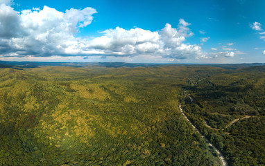 Fototapeta premium above the road to the village of Mirny (Western Caucasus. South of Russia) in early autumn - in the mountains the higher. the leaves are yellower