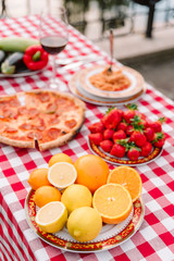 Table with bright, fresh fruit and other food outdoors for a seed lunch