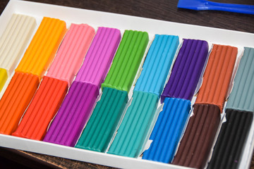 new packaging of multi-colored bright plasticine lies