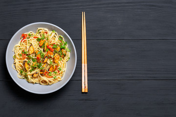 Pasta Spaghetti seafood with mussels Marinara, Typical dish of Italian pasta. top view. on a black background with a place for text, copy space