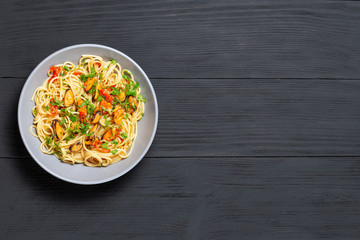 Pasta Spaghetti seafood with mussels Marinara, Typical dish of Italian pasta. top view. on a black background with a place for text, copy space