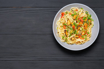 Pasta Spaghetti seafood with mussels Marinara, Typical dish of Italian pasta. top view. on a black background with a place for text, copy space