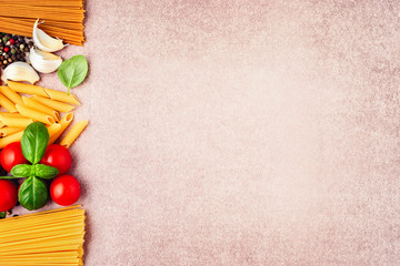 Pasta ingredients on light rustic background with copy space