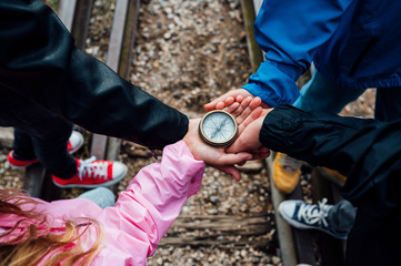 Group of children holding a compass © karrastock