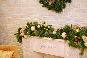 Fototapeta na wymiar A festive room. New year. A bright beige room Christmas décor, pine green decoration, balls, toys.