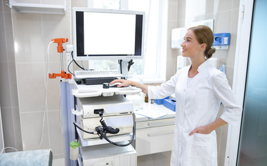 Obraz premium Young woman working with ultrasound machine stock photo