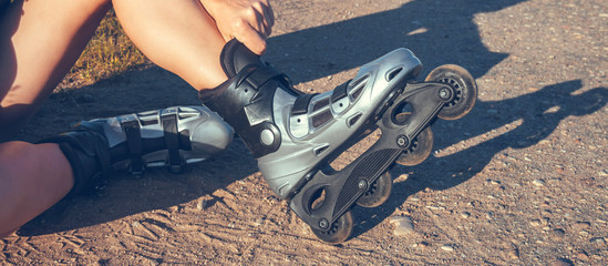 teenage girl rollerblading on the street on the road in the countryside on a summer evening  sunset