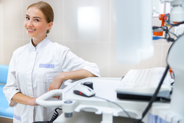 Smiling young specialist in ultrasound office stock photo