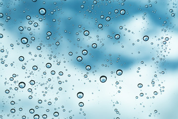Rain on the window, natural skin of the rain The natural form of rainwater on a sky background.