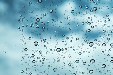 Rain on the window, natural skin of the rain The natural form of rainwater on a sky background.