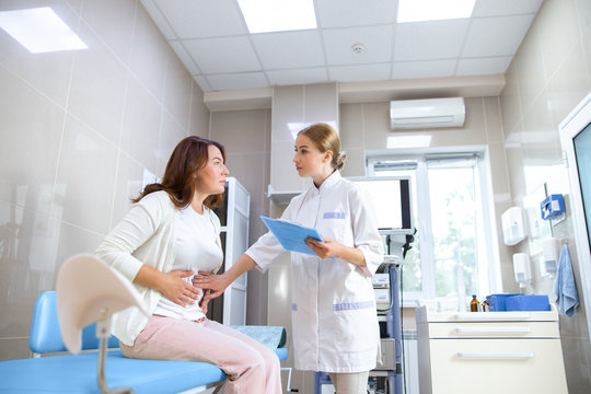 Attentive young doctor consulting woman stock photo