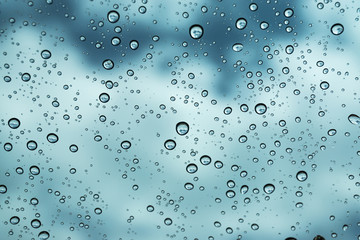 Rain on the window, natural skin of the rain The natural form of rainwater on a sky background.