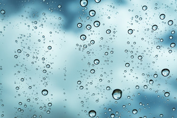 Rain on the window, natural skin of the rain The natural form of rainwater on a sky background.