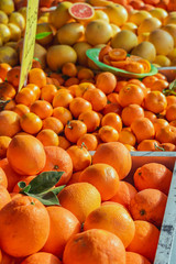 Fresh oranges on market stall at weekly spanish marketplace. Food background close up shot with selective focus