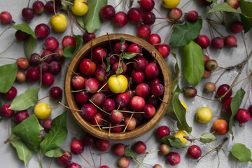  wooden bowl with fruits gray background flat lay