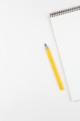 open notebook on white table top view, with blank page