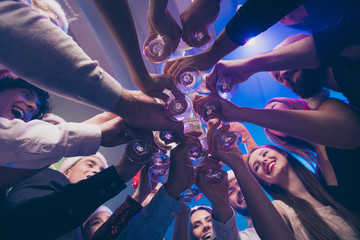 Low below angle view of nice attractive cheerful cheery positive girls and guys having fun weekend...