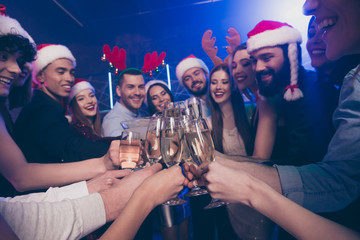 Close-up view of nice attractive glamorous cheerful cheery positive girls and guys having fun rest relax congrats amusement feast festive in luxury place nightclub indoors