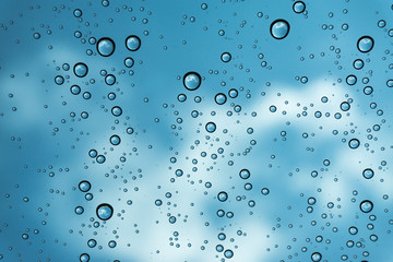 Rain on the window, natural skin of the rain The natural form of rainwater on a sky background.