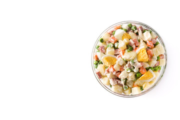Traditional Russian salad in bowl. Olivier salad isolated on white background. Top view. Copy space