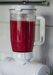 Hands of a woman on a blender. The process of preparing soup or smoothies in a kitchen blender. healthy and vegan diet. Close up