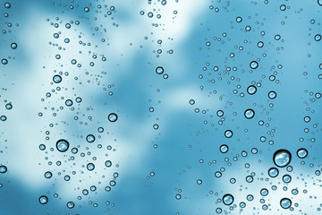 Rain on the window, natural skin of the rain The natural form of rainwater on a sky background.