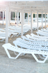 Beach with sun loungers.  Sunbeds on the beach are in rows