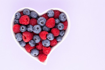 Creative layout made of Blueberry and raspberries on pastel background. Food ingredient pattern.