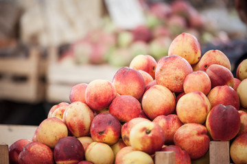 Ripe peaches, orange and red, for sale on a market in Belgrade, Serbia piled on a stall. These are among the most traditional fruits of the Balkan peninsula