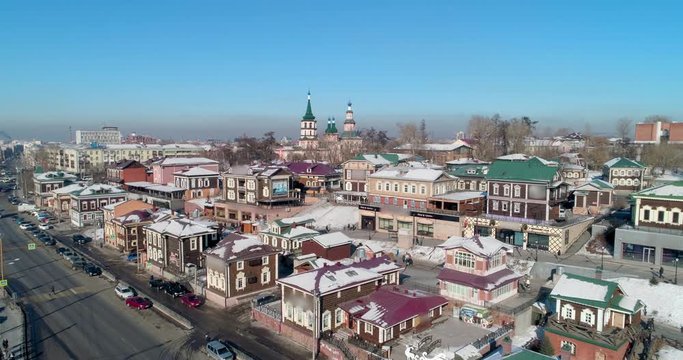 Aerial: Drone ascending on snow covered buildings in city - Irkutsk, Russia