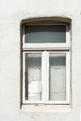 white concrete wall with broken glass, windows 