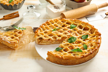 Tasty apple pie on light table