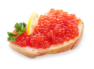 Slice of bread with red caviar and lemon on white background