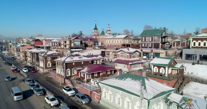 Aerial: Drone approaching snow covered buildings on sunny day - Irkutsk, Russia