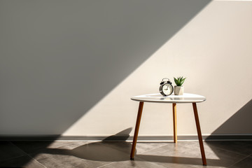 Small table near grey wall