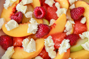 Tasty salad with peach and raspberry, closeup