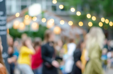 Blurred background. Blurred background on the street with lights-lanterns. Street festival.