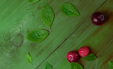Plums on wooden table. Top view.