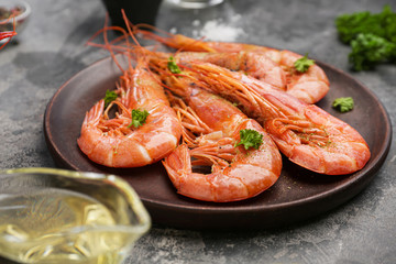Plate with tasty shrimps on grey table