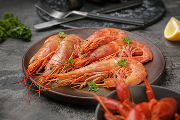 Plate with tasty shrimps on grey table