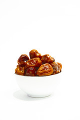 Bowl of dates isolated on white background