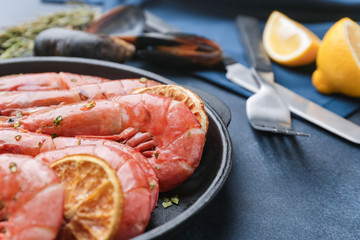Frying pan with tasty shrimps on table