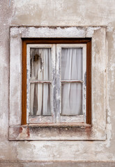 Obraz na płótnie Canvas Nazare, Portugal - An old broken window in an abandoned house