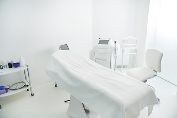 Interior of cosmetologist cabinet with epilation equipment in modern spa salon