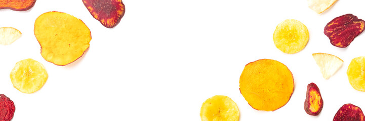 A panorama of dry fruit and vegetable chips, shot from the top on a white background with a place...