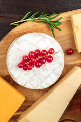 Camembert cheese, overhead shot with other cheeses and fruit