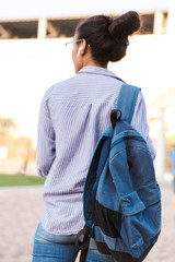 Attractive young african woman student carrying backpack