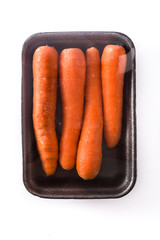 Carrots packaged in plastic isolated on white background. Top view