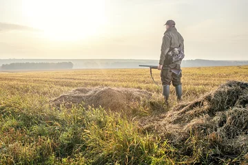 Deurstickers Hunter in the fall hunting season. Pheasant Hunter. © Sergey