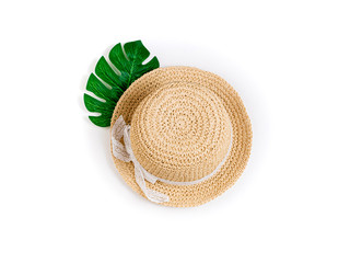 Summer background with straw hat and tropical palm leaf monstera. Female summer accessories. Summer, outfit, fashion, vacations, travel concept